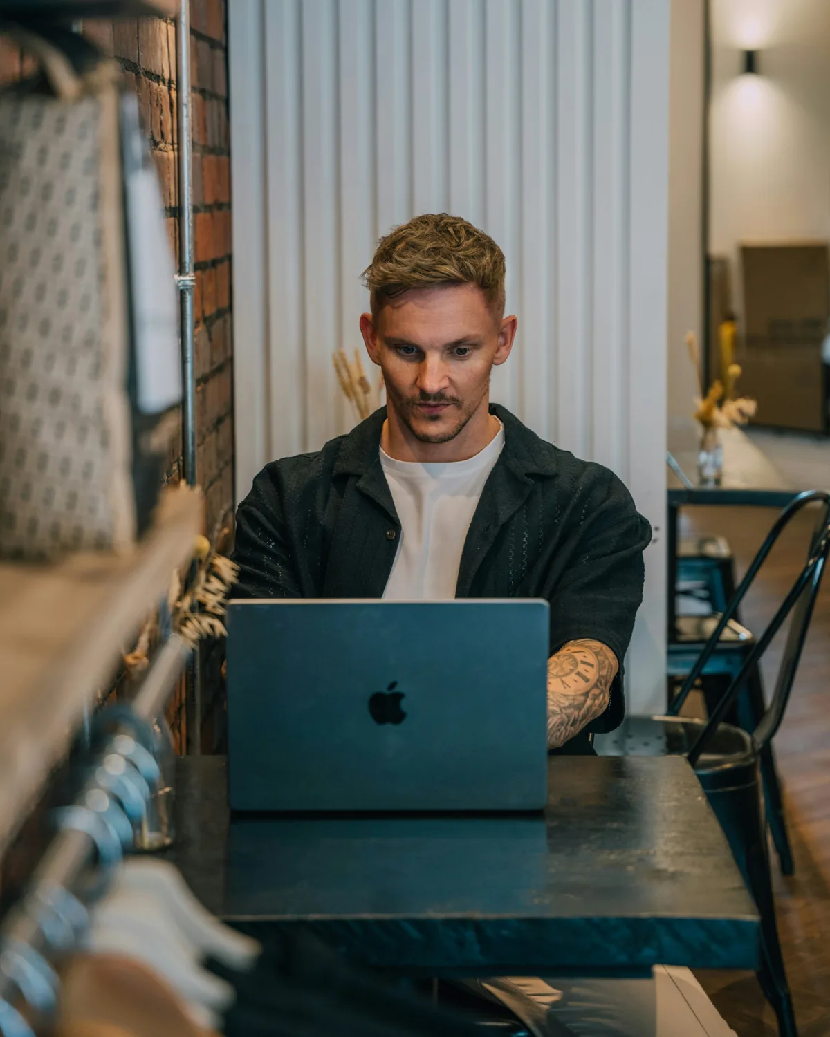 Paolo working on a laptop at a café